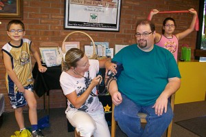Pioneer Home Care Aug. 30-Sept. 4, 2010; Steven Sprouse gets his blood pressure checked by Megan Hancock, Therapist; Hannah and Caleb Sprouse are doing exercise with a THERA-BAND (Arm strengthening, Leg strengthening)