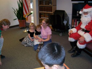 children and Santa Claus listening to story teller